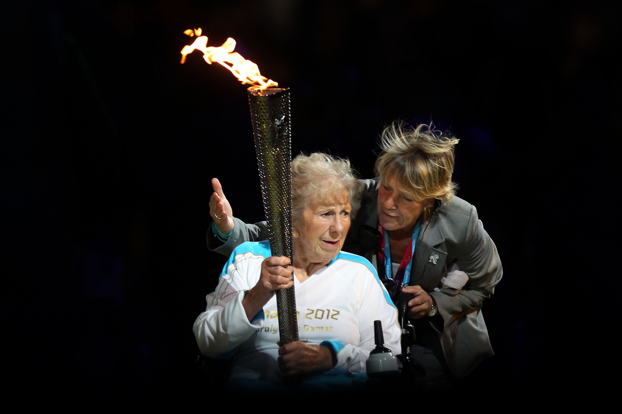 Paralympian Margaret Maughan carries the flame during the Opening Ceremony of the London 2012 Paralympics at the Olympic Stadium ©Getty Images