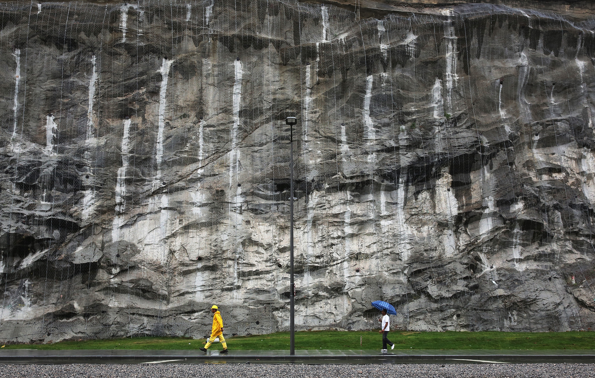 A man and construction worker walk along the newly inaugurated Via Binario do Porto, a new transit route in the port district ©Getty Images