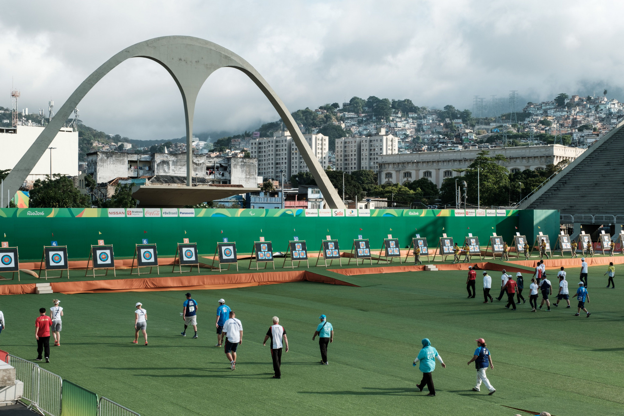 Coaches walk for targets during the ranking round for individual (W1) and individual Compound (open) of the Rio 2016 Paralympic Games at the Sambodromo ©Getty Images